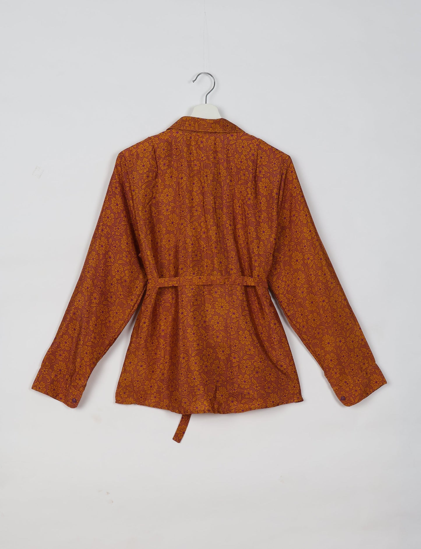 Experience sustainable fashion with our classic slim-fit shirt, crafted with ethical and green values. The shirt, designed for minimal waste, features a tie-up waist belt or neck tie, semi-spread collar, and regular shirt cuffs. Versatile and eco-friendly, wear it tucked in, unbuttoned over a tank top, or knotted at the waist for a unique style.