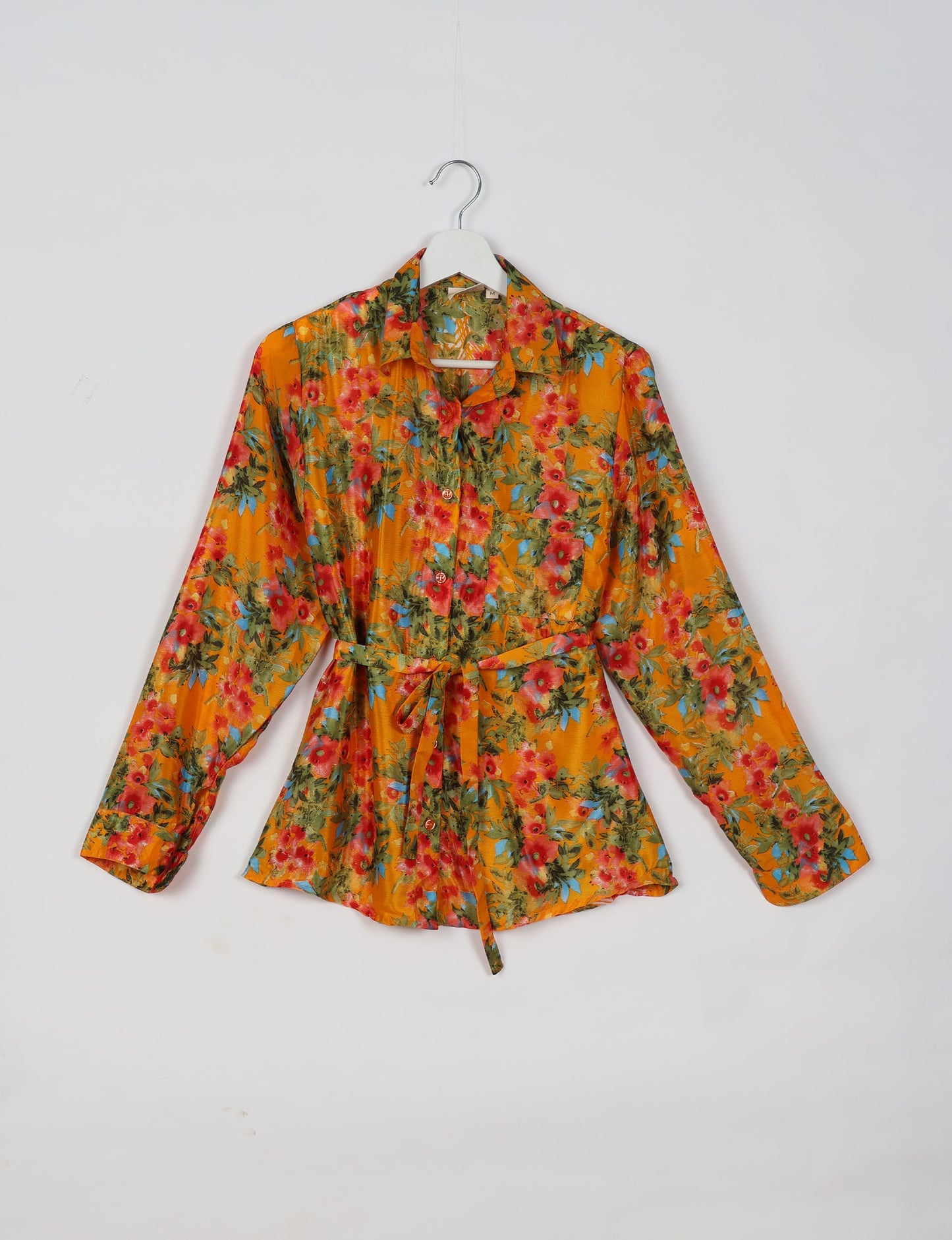 Experience sustainable fashion with our classic slim-fit shirt, crafted with ethical and green values. The shirt, designed for minimal waste, features a tie-up waist belt or neck tie, semi-spread collar, and regular shirt cuffs. Versatile and eco-friendly, wear it tucked in, unbuttoned over a tank top, or knotted at the waist for a unique style.