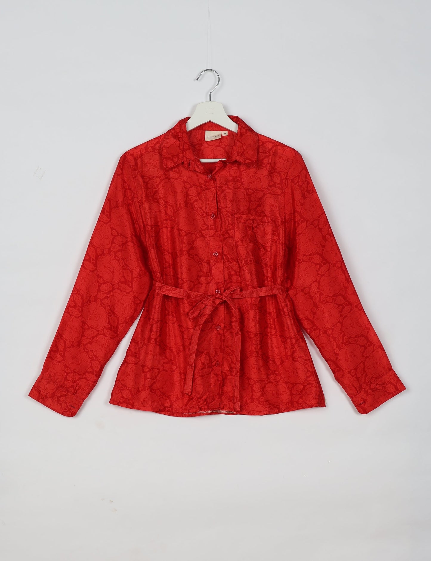 Experience sustainable fashion with our classic slim-fit shirt, crafted with ethical and green values. The shirt, designed for minimal waste, features a tie-up waist belt or neck tie, semi-spread collar, and regular shirt cuffs. Versatile and eco-friendly, wear it tucked in, unbuttoned over a tank top, or knotted at the waist for a unique style.