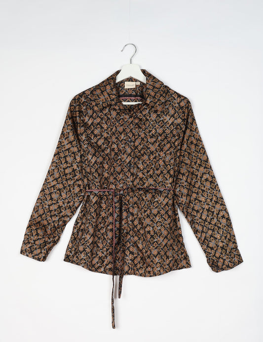 Experience sustainable fashion with our classic slim-fit shirt, crafted with ethical and green values. The shirt, designed for minimal waste, features a tie-up waist belt or neck tie, semi-spread collar, and regular shirt cuffs. Versatile and eco-friendly, wear it tucked in, unbuttoned over a tank top, or knotted at the waist for a unique style.