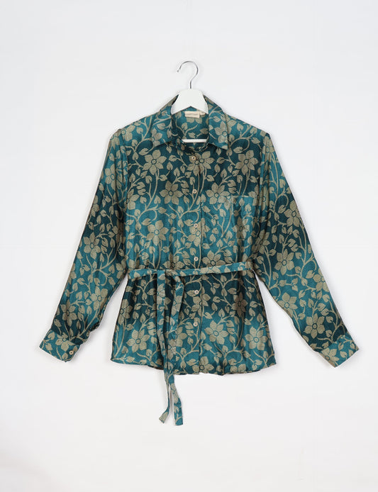 Experience sustainable fashion with our classic slim-fit shirt, crafted with ethical and green values. The shirt, designed for minimal waste, features a tie-up waist belt or neck tie, semi-spread collar, and regular shirt cuffs. Versatile and eco-friendly, wear it tucked in, unbuttoned over a tank top, or knotted at the waist for a unique style.