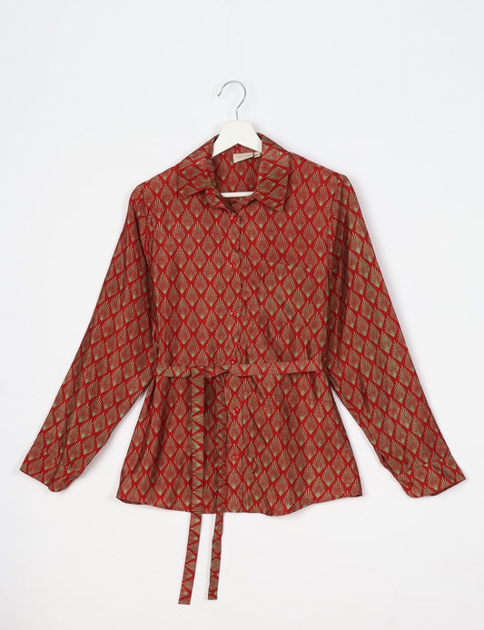 Experience sustainable fashion with our classic slim-fit shirt, crafted with ethical and green values. The shirt, designed for minimal waste, features a tie-up waist belt or neck tie, semi-spread collar, and regular shirt cuffs. Versatile and eco-friendly, wear it tucked in, unbuttoned over a tank top, or knotted at the waist for a unique style.