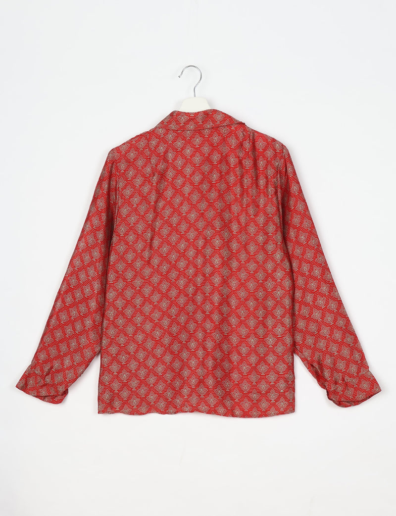 Red long-sleeve shirt with beige leaf pattern, spread collar, and buttoned cuffs, shown from back on white hanger