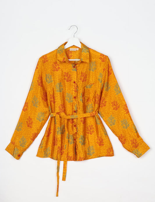 Experience sustainable fashion with our classic slim-fit shirt, crafted with ethical and green values. The shirt, designed for minimal waste, features a tie-up waist belt or neck tie, semi-spread collar, and regular shirt cuffs. Versatile and eco-friendly, wear it tucked in, unbuttoned over a tank top, or knotted at the waist for a unique style.