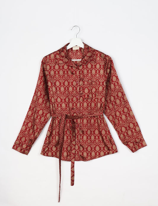 Experience sustainable fashion with our classic slim-fit shirt, crafted with ethical and green values. The shirt, designed for minimal waste, features a tie-up waist belt or neck tie, semi-spread collar, and regular shirt cuffs. Versatile and eco-friendly, wear it tucked in, unbuttoned over a tank top, or knotted at the waist for a unique style.