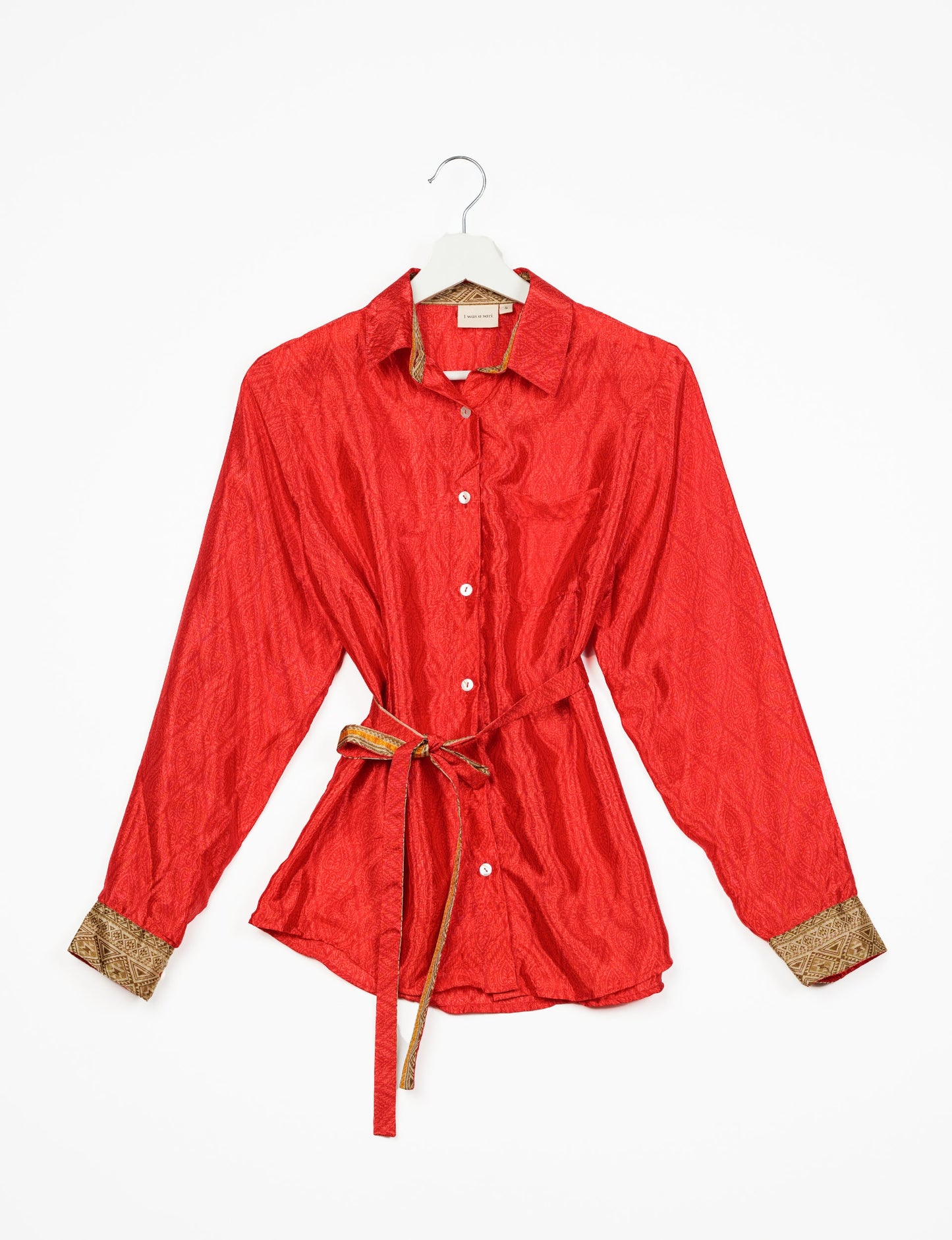 Experience sustainable fashion with our classic slim-fit shirt, crafted with ethical and green values. The shirt, designed for minimal waste, features a tie-up waist belt or neck tie, semi-spread collar, and regular shirt cuffs. Versatile and eco-friendly, wear it tucked in, unbuttoned over a tank top, or knotted at the waist for a unique style.