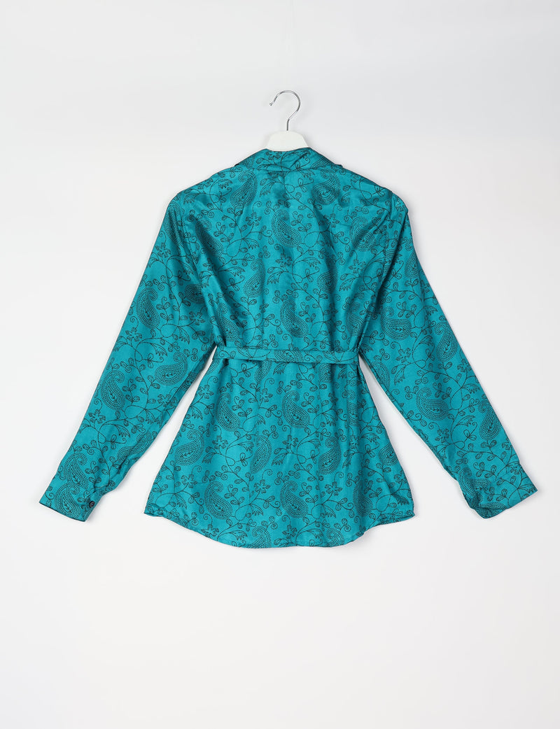 Blue long-sleeve shirt with black paisley and floral print, belted waist, shown from back on white hanger against white background