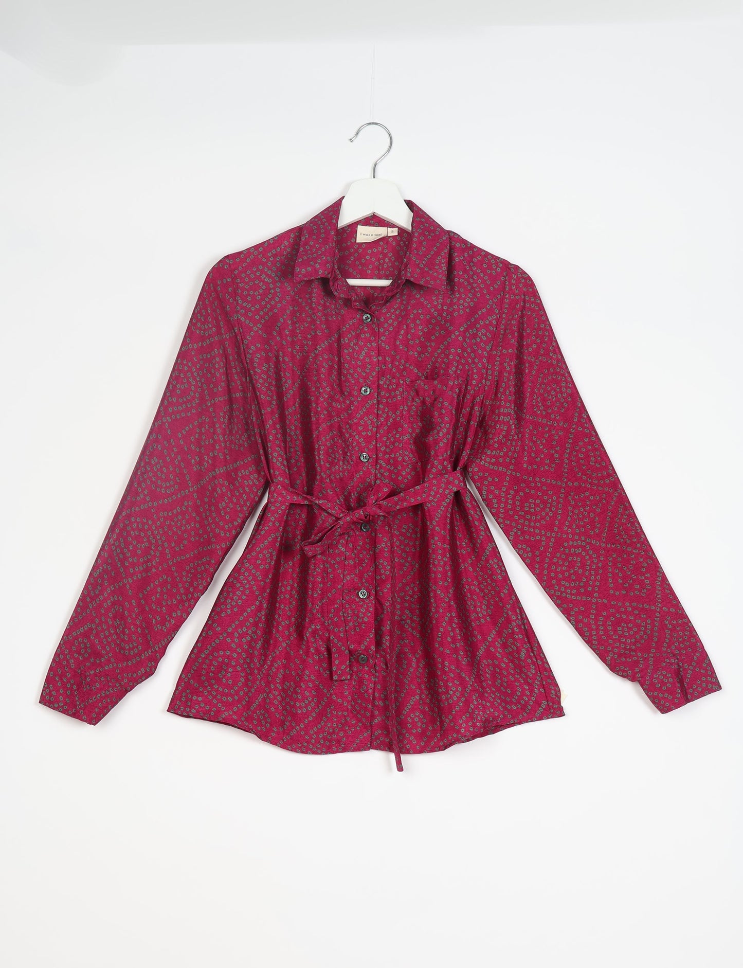 Experience sustainable fashion with our classic slim-fit shirt, crafted with ethical and green values. The shirt, designed for minimal waste, features a tie-up waist belt or neck tie, semi-spread collar, and regular shirt cuffs. Versatile and eco-friendly, wear it tucked in, unbuttoned over a tank top, or knotted at the waist for a unique style.