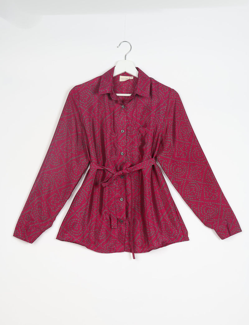 Long-sleeve button-up shirt in dark pink with small gray geometric dot pattern and waist tie, front view on hanger