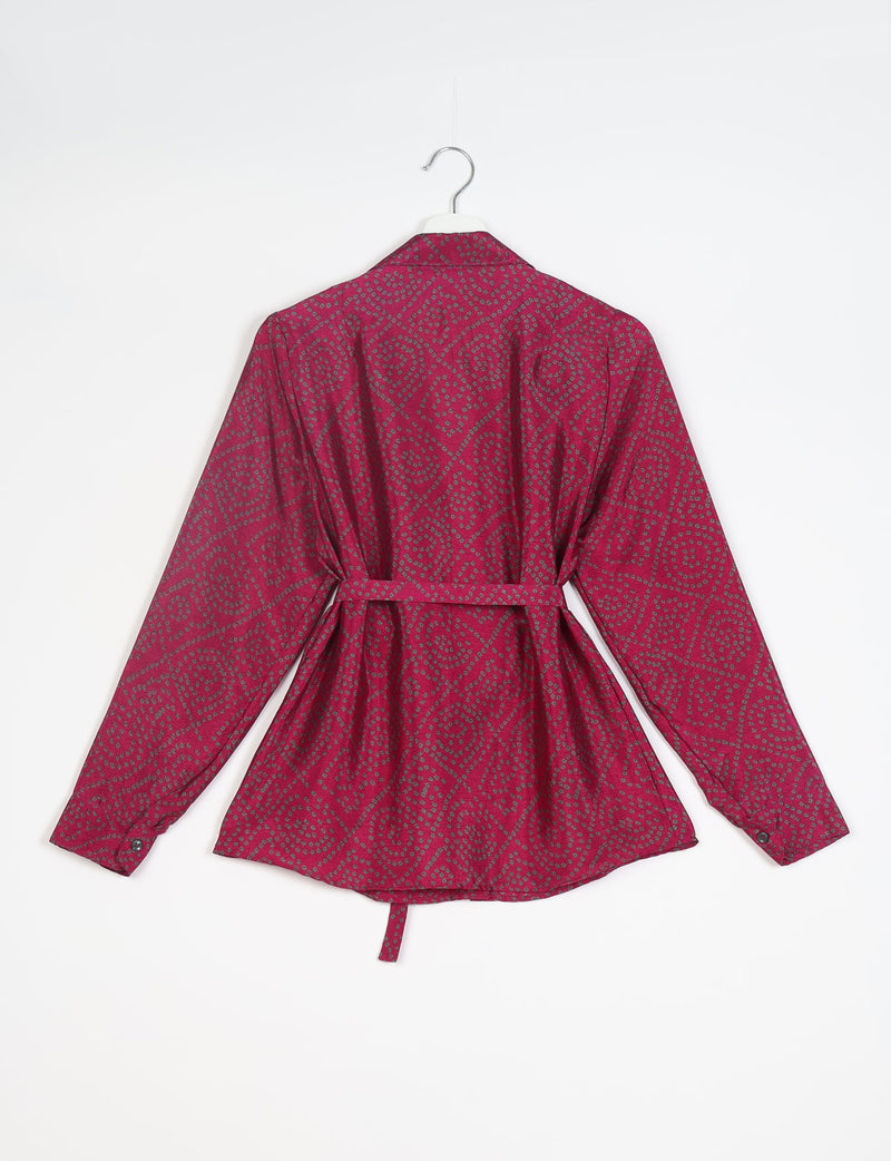 Long-sleeve red shirt with gray geometric dot pattern, buttoned cuffs, collar, and waist tie, shown from back on hanger