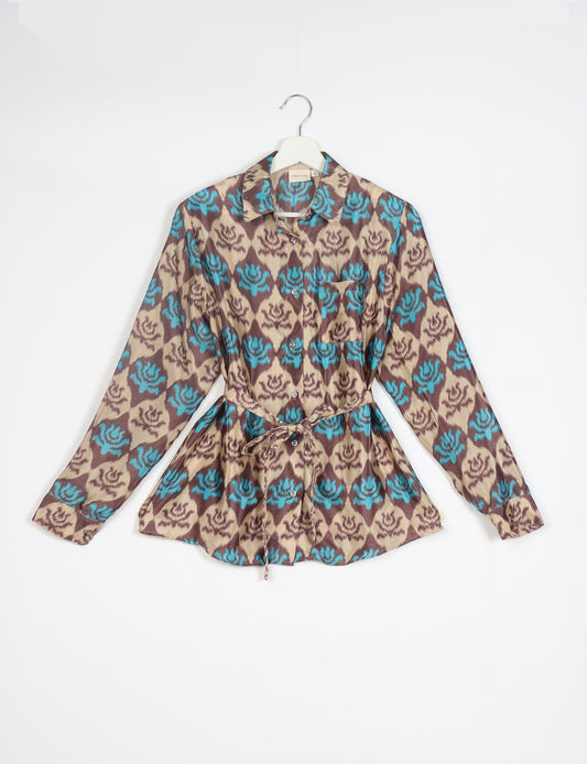 Experience sustainable fashion with our classic slim-fit shirt, crafted with ethical and green values. The shirt, designed for minimal waste, features a tie-up waist belt or neck tie, semi-spread collar, and regular shirt cuffs. Versatile and eco-friendly, wear it tucked in, unbuttoned over a tank top, or knotted at the waist for a unique style.