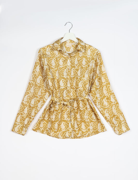 Experience sustainable fashion with our classic slim-fit shirt, crafted with ethical and green values. The shirt, designed for minimal waste, features a tie-up waist belt or neck tie, semi-spread collar, and regular shirt cuffs. Versatile and eco-friendly, wear it tucked in, unbuttoned over a tank top, or knotted at the waist for a unique style.