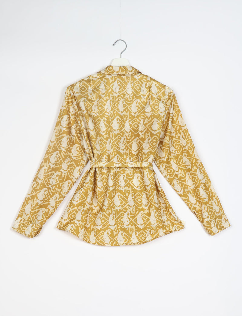 Long-sleeve shirt with beige and white abstract geometric pattern, back view, hanging on white hanger against white background