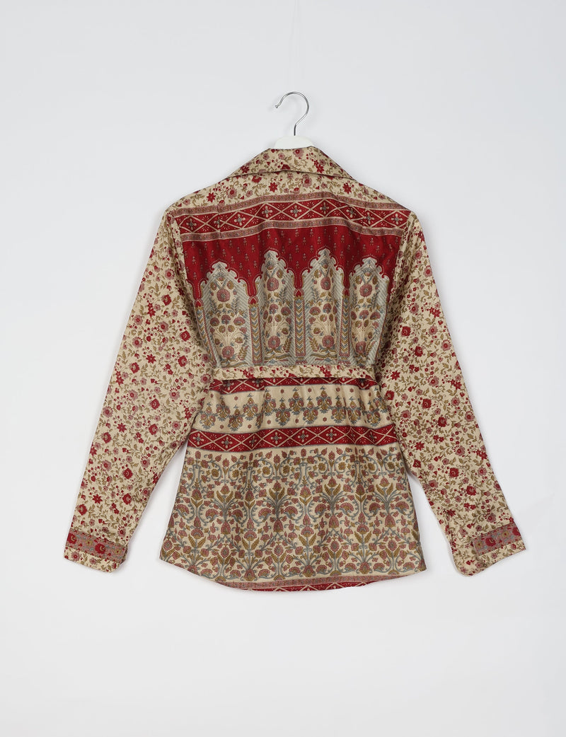 Beige long-sleeve shirt with red and multicolor floral and geometric tropical patterns, shown from back on hanger