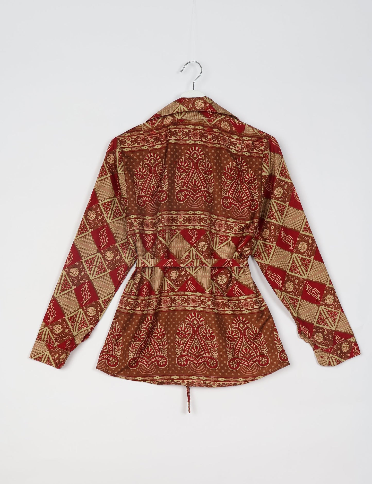 Experience sustainable fashion with our classic slim-fit shirt, crafted with ethical and green values. The shirt, designed for minimal waste, features a tie-up waist belt or neck tie, semi-spread collar, and regular shirt cuffs. Versatile and eco-friendly, wear it tucked in, unbuttoned over a tank top, or knotted at the waist for a unique style.