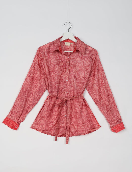 Experience sustainable fashion with our classic slim-fit shirt, crafted with ethical and green values. The shirt, designed for minimal waste, features a tie-up waist belt or neck tie, semi-spread collar, and regular shirt cuffs. Versatile and eco-friendly, wear it tucked in, unbuttoned over a tank top, or knotted at the waist for a unique style.