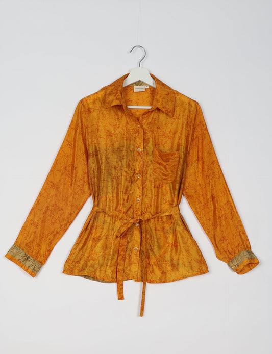 Experience sustainable fashion with our classic slim-fit shirt, crafted with ethical and green values. The shirt, designed for minimal waste, features a tie-up waist belt or neck tie, semi-spread collar, and regular shirt cuffs. Versatile and eco-friendly, wear it tucked in, unbuttoned over a tank top, or knotted at the waist for a unique style.