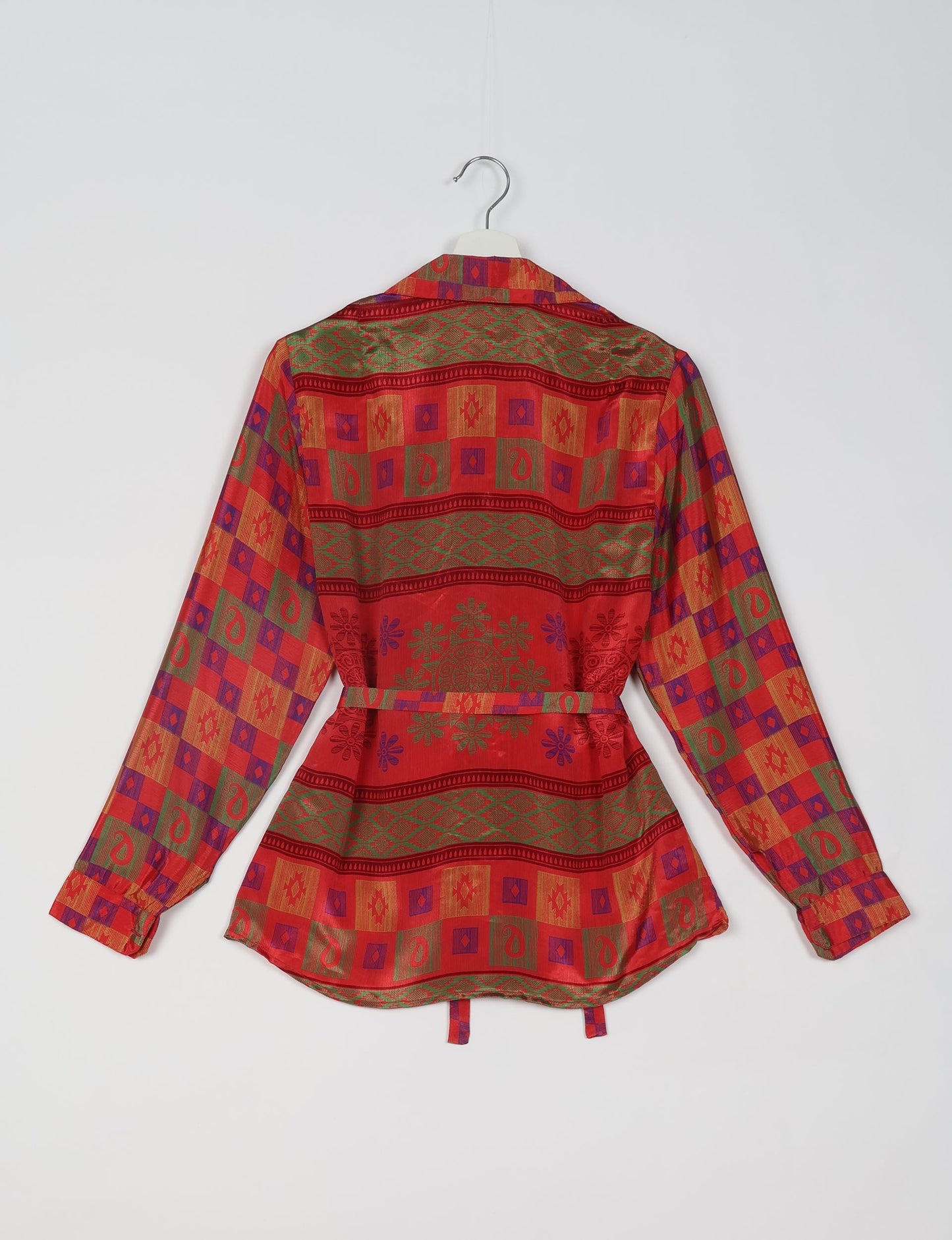 Experience sustainable fashion with our classic slim-fit shirt, crafted with ethical and green values. The shirt, designed for minimal waste, features a tie-up waist belt or neck tie, semi-spread collar, and regular shirt cuffs. Versatile and eco-friendly, wear it tucked in, unbuttoned over a tank top, or knotted at the waist for a unique style.