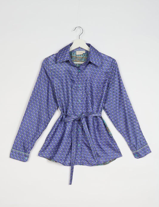 Experience sustainable fashion with our classic slim-fit shirt, crafted with ethical and green values. The shirt, designed for minimal waste, features a tie-up waist belt or neck tie, semi-spread collar, and regular shirt cuffs. Versatile and eco-friendly, wear it tucked in, unbuttoned over a tank top, or knotted at the waist for a unique style.