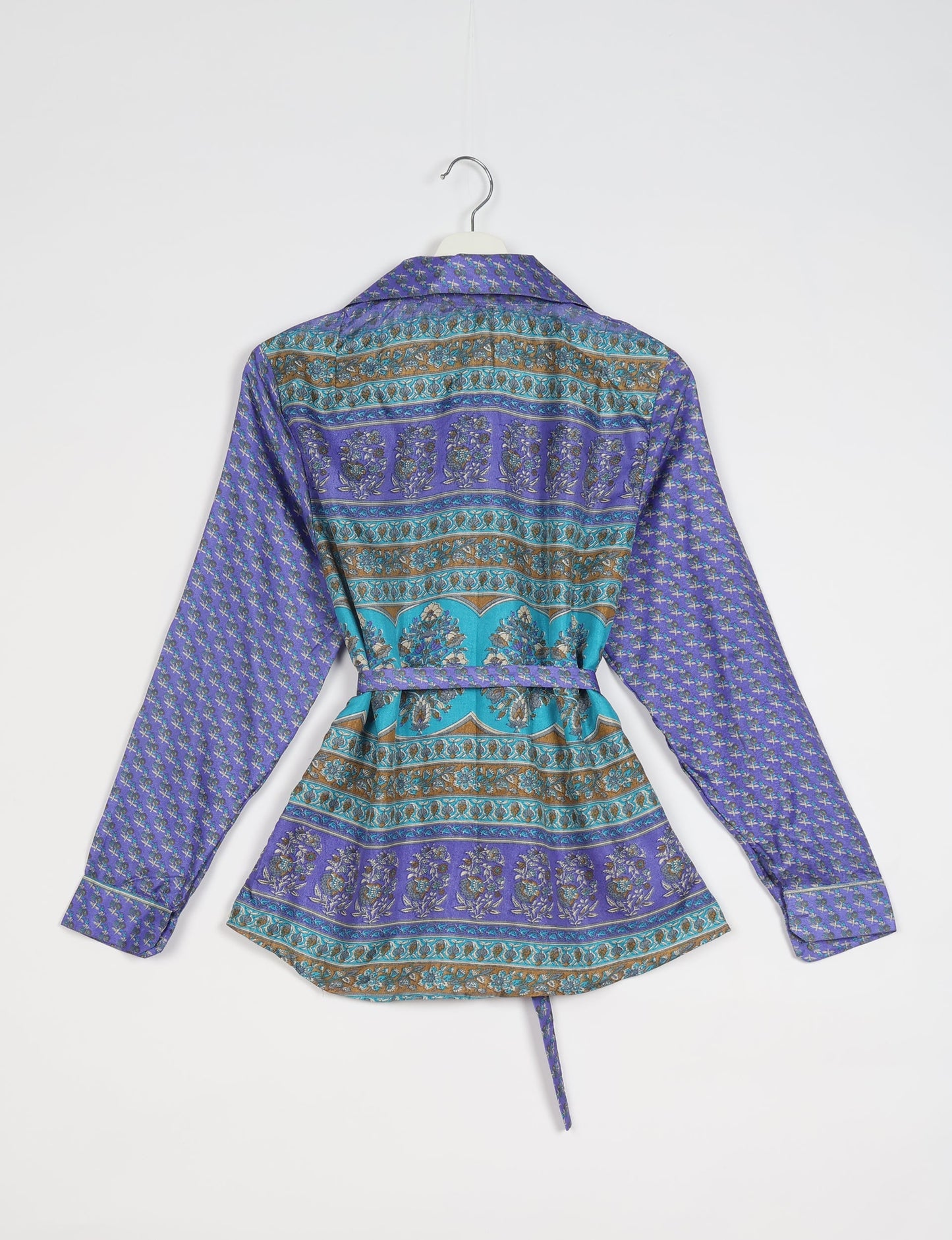 Experience sustainable fashion with our classic slim-fit shirt, crafted with ethical and green values. The shirt, designed for minimal waste, features a tie-up waist belt or neck tie, semi-spread collar, and regular shirt cuffs. Versatile and eco-friendly, wear it tucked in, unbuttoned over a tank top, or knotted at the waist for a unique style.