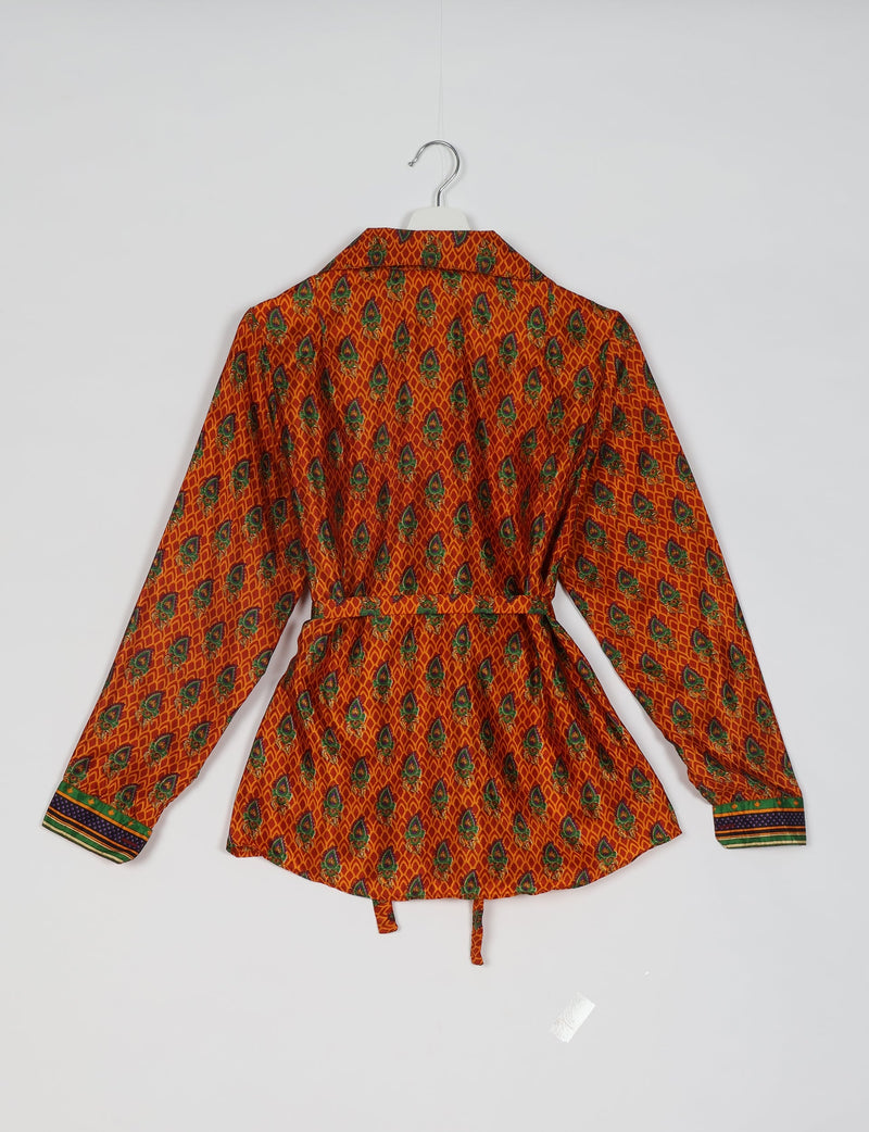Orange long-sleeve shirt with green and blue micro floral pattern, belted waist, and striped cuffs, shown from back on hanger