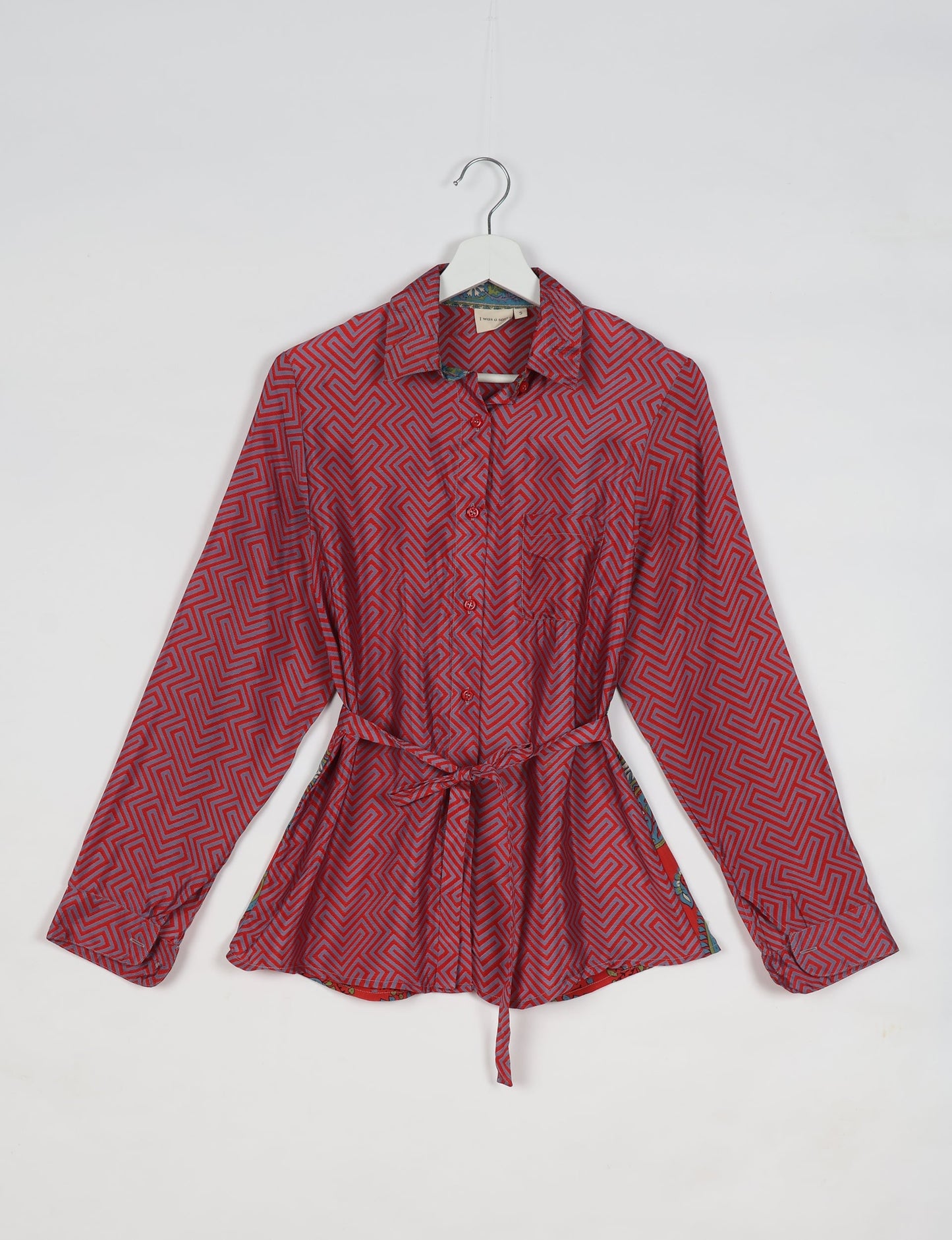 Experience sustainable fashion with our classic slim-fit shirt, crafted with ethical and green values. The shirt, designed for minimal waste, features a tie-up waist belt or neck tie, semi-spread collar, and regular shirt cuffs. Versatile and eco-friendly, wear it tucked in, unbuttoned over a tank top, or knotted at the waist for a unique style.