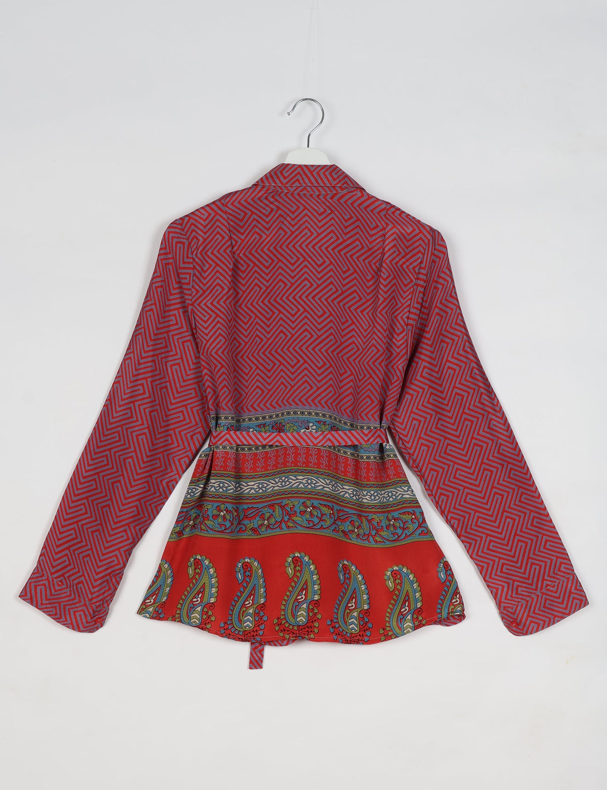 Long-sleeve pink shirt with geometric maze pattern on top and multicolor floral paisley border, back view on hanger