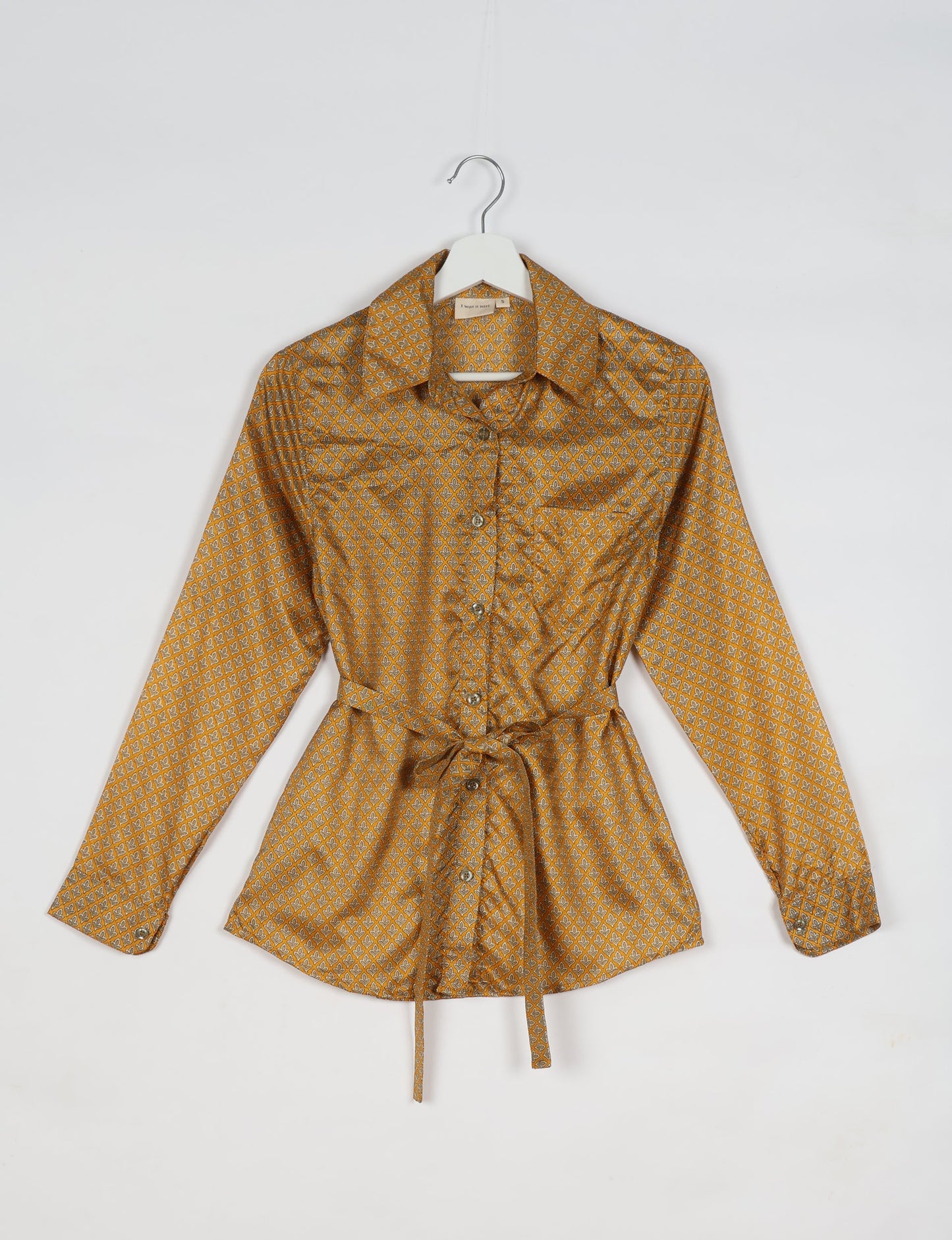 Experience sustainable fashion with our classic slim-fit shirt, crafted with ethical and green values. The shirt, designed for minimal waste, features a tie-up waist belt or neck tie, semi-spread collar, and regular shirt cuffs. Versatile and eco-friendly, wear it tucked in, unbuttoned over a tank top, or knotted at the waist for a unique style.