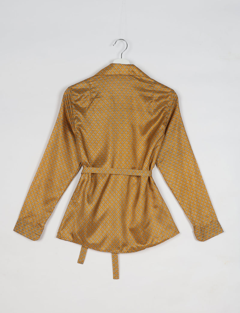 Experience sustainable fashion with our classic slim-fit shirt, crafted with ethical and green values. The shirt, designed for minimal waste, features a tie-up waist belt or neck tie, semi-spread collar, and regular shirt cuffs. Versatile and eco-friendly, wear it tucked in, unbuttoned over a tank top, or knotted at the waist for a unique style.