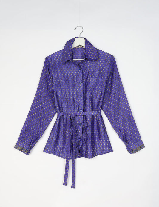 Experience sustainable fashion with our classic slim-fit shirt, crafted with ethical and green values. The shirt, designed for minimal waste, features a tie-up waist belt or neck tie, semi-spread collar, and regular shirt cuffs. Versatile and eco-friendly, wear it tucked in, unbuttoned over a tank top, or knotted at the waist for a unique style.