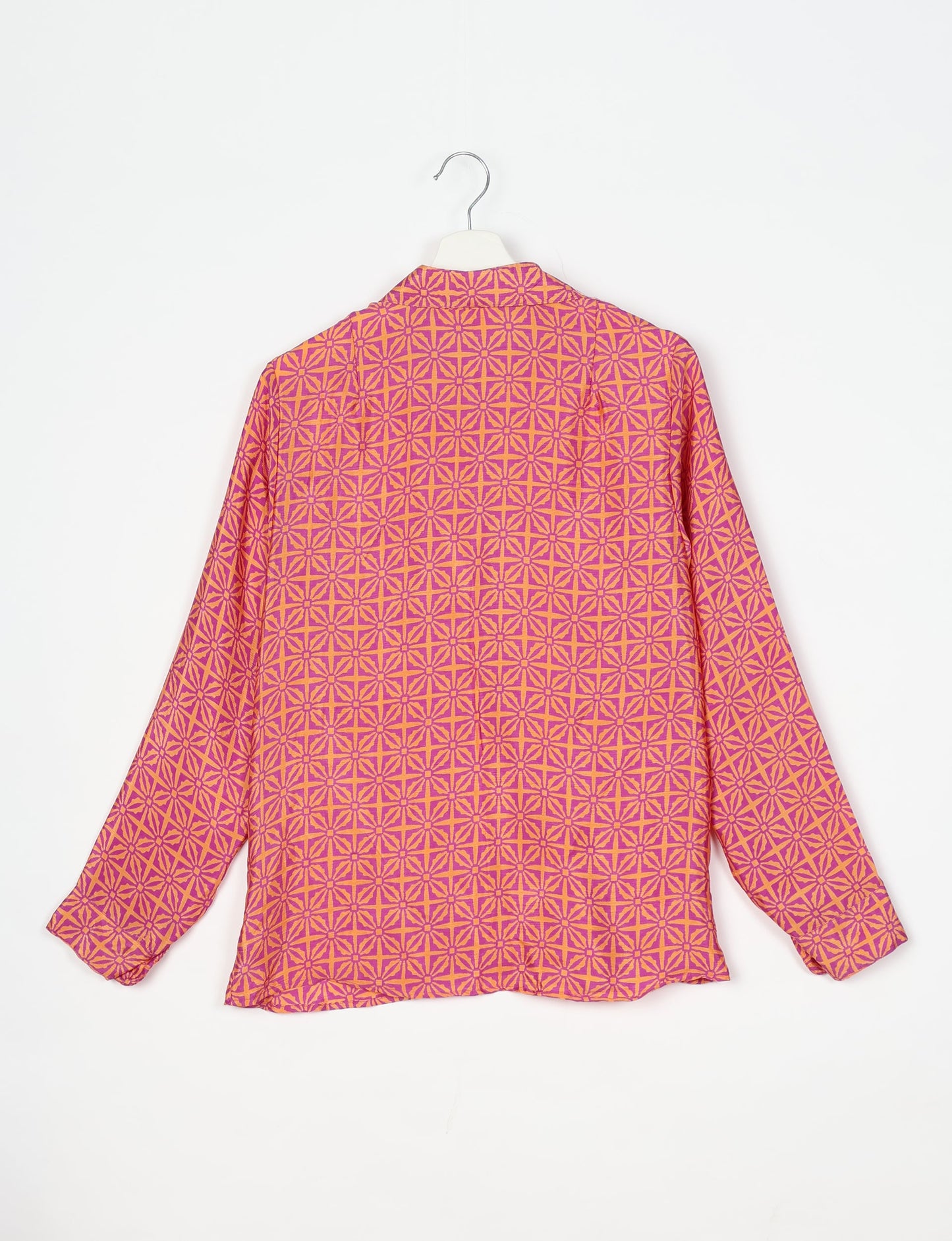 Experience sustainable fashion with our classic slim-fit shirt, crafted with ethical and green values. The shirt, designed for minimal waste, features a tie-up waist belt or neck tie, semi-spread collar, and regular shirt cuffs. Versatile and eco-friendly, wear it tucked in, unbuttoned over a tank top, or knotted at the waist for a unique style.