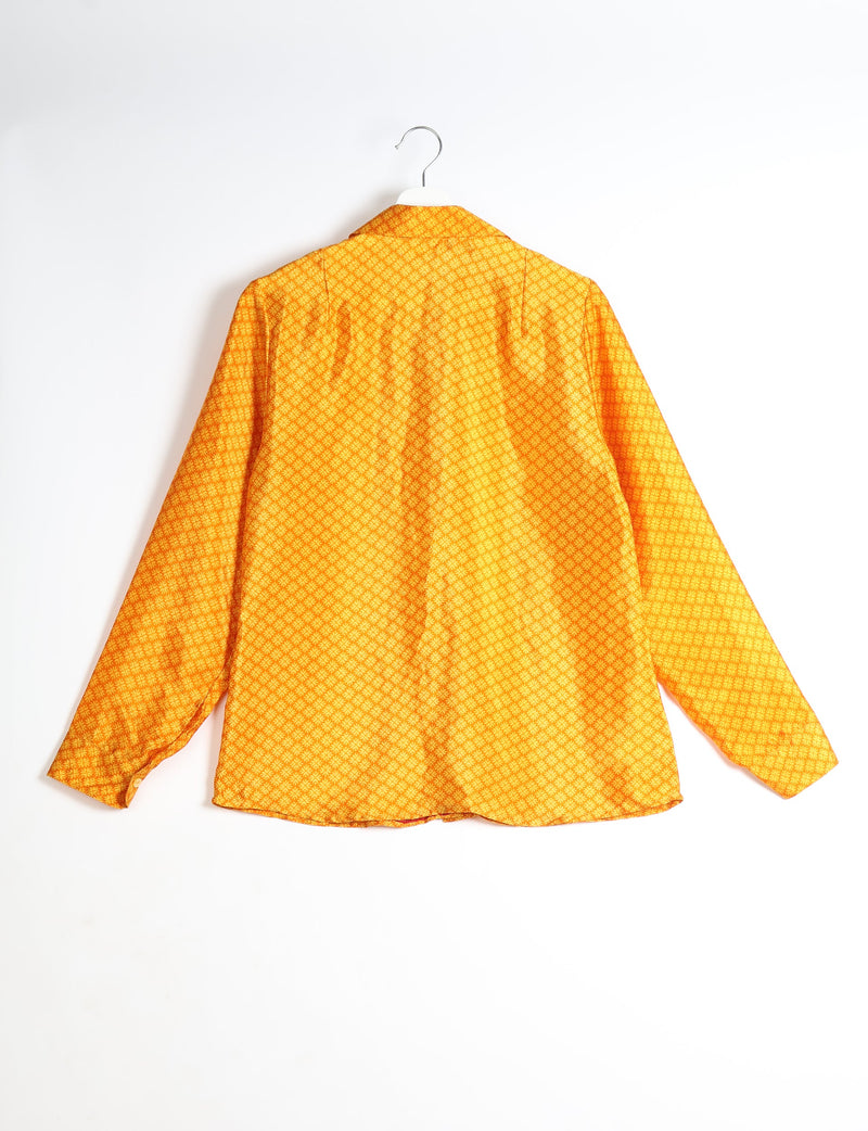 Yellow long-sleeve shirt with micro geometric pattern, shown from back, hanging on white hanger against white background