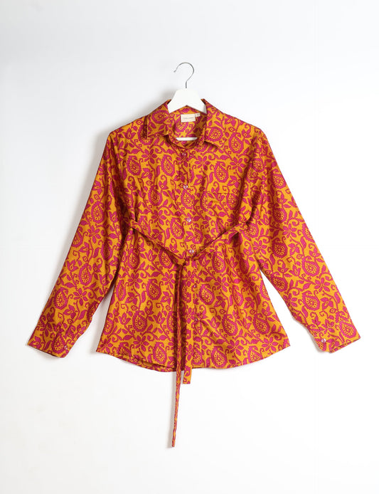 Experience sustainable fashion with our classic slim-fit shirt, crafted with ethical and green values. The shirt, designed for minimal waste, features a tie-up waist belt or neck tie, semi-spread collar, and regular shirt cuffs. Versatile and eco-friendly, wear it tucked in, unbuttoned over a tank top, or knotted at the waist for a unique style.