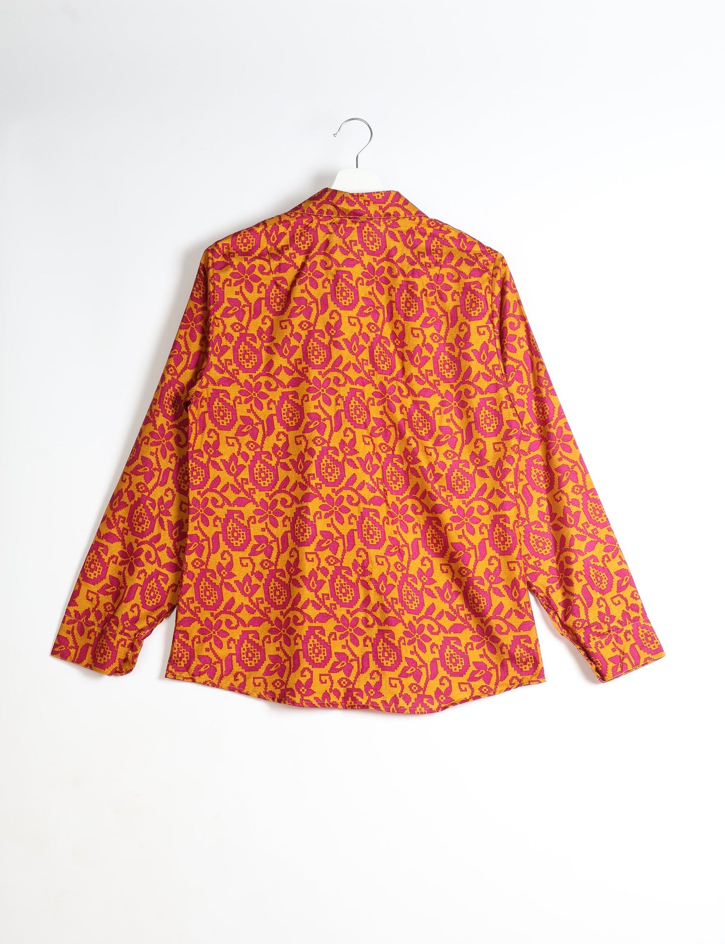 Experience sustainable fashion with our classic slim-fit shirt, crafted with ethical and green values. The shirt, designed for minimal waste, features a tie-up waist belt or neck tie, semi-spread collar, and regular shirt cuffs. Versatile and eco-friendly, wear it tucked in, unbuttoned over a tank top, or knotted at the waist for a unique style.