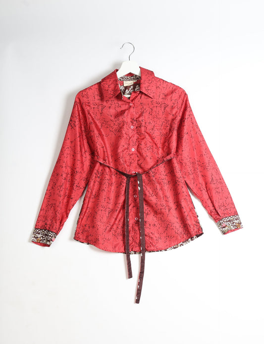 Experience sustainable fashion with our classic slim-fit shirt, crafted with ethical and green values. The shirt, designed for minimal waste, features a tie-up waist belt or neck tie, semi-spread collar, and regular shirt cuffs. Versatile and eco-friendly, wear it tucked in, unbuttoned over a tank top, or knotted at the waist for a unique style.