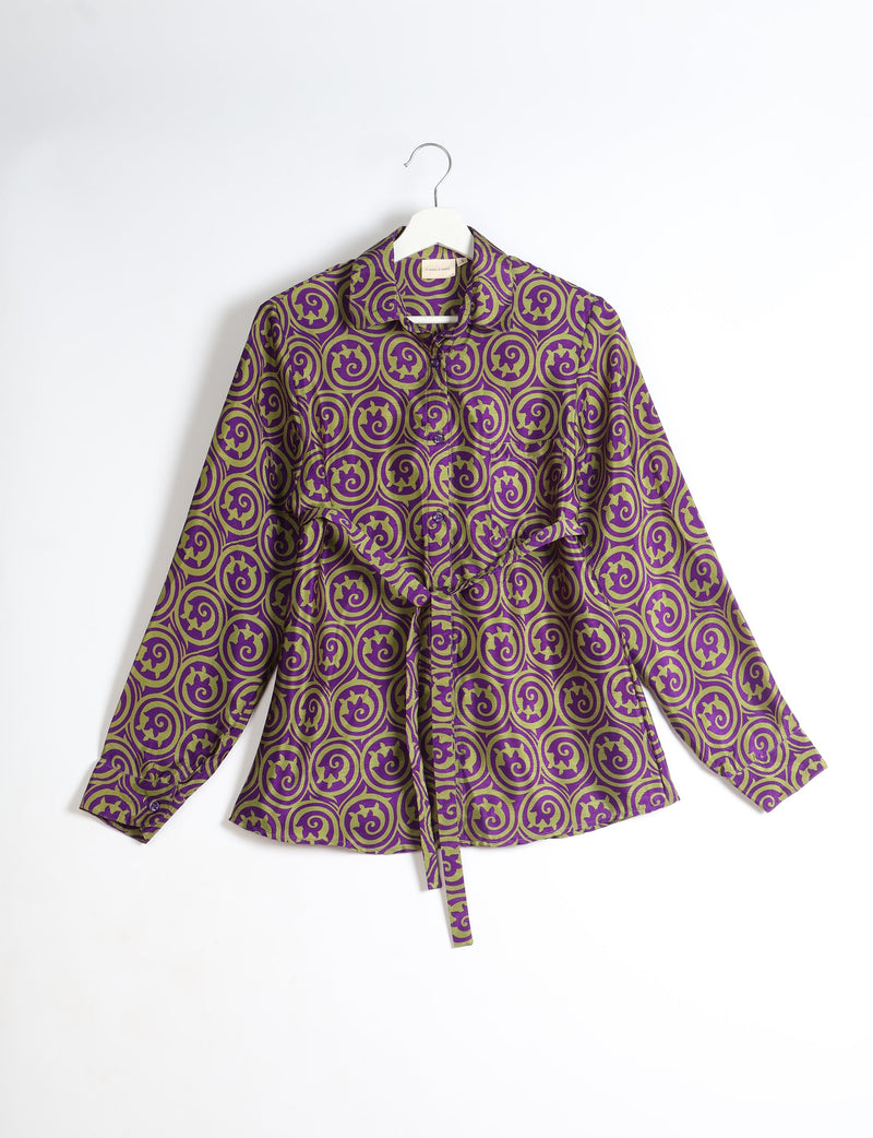 Purple and olive green abstract patterned long-sleeve shirt with collar and front buttons, hanging on white hanger
