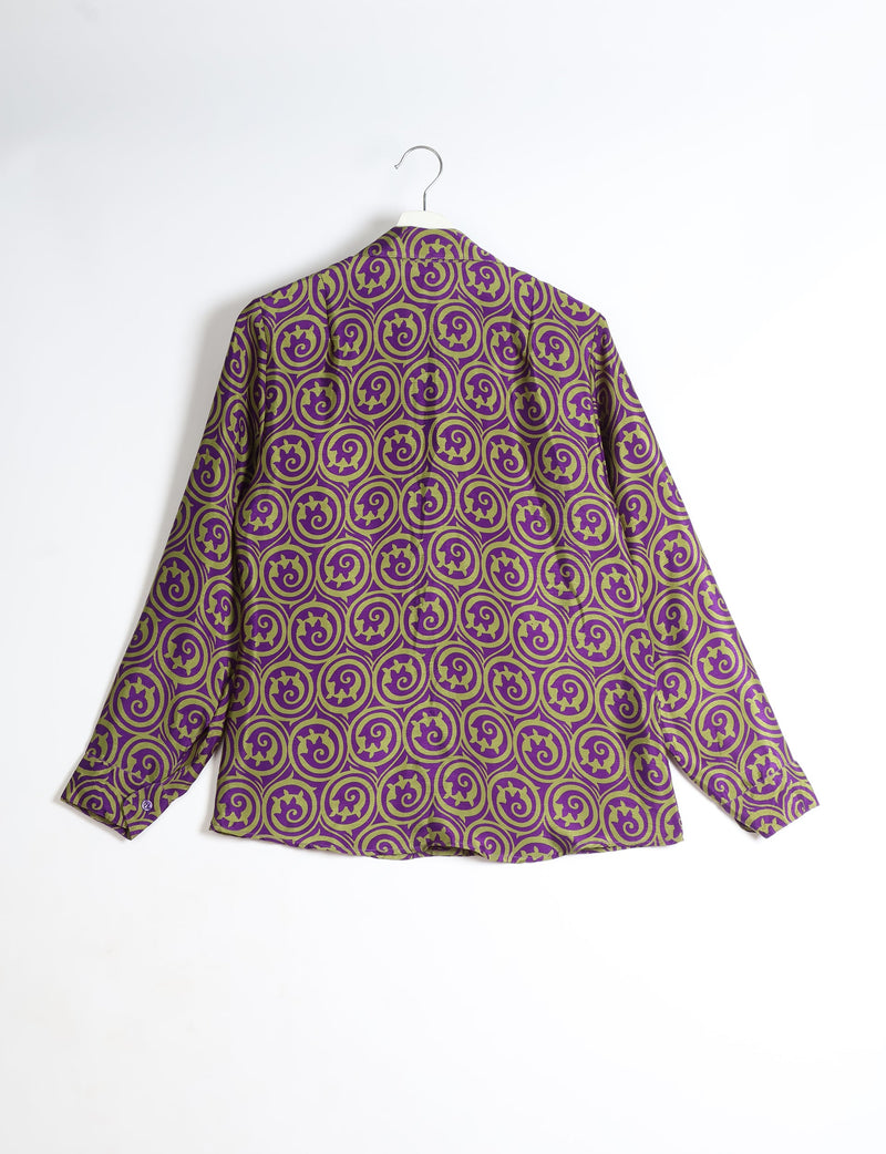 Purple long-sleeve shirt with green circular abstract pattern, shown from back, hanging on white hanger against white background