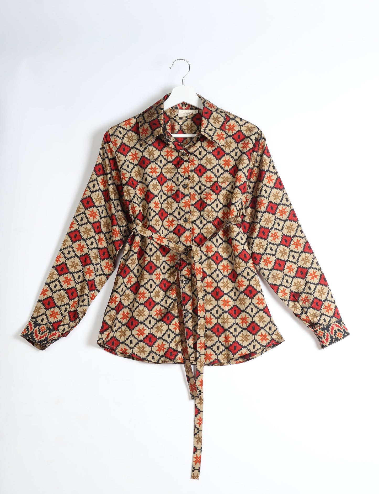 Experience sustainable fashion with our classic slim-fit shirt, crafted with ethical and green values. The shirt, designed for minimal waste, features a tie-up waist belt or neck tie, semi-spread collar, and regular shirt cuffs. Versatile and eco-friendly, wear it tucked in, unbuttoned over a tank top, or knotted at the waist for a unique style.