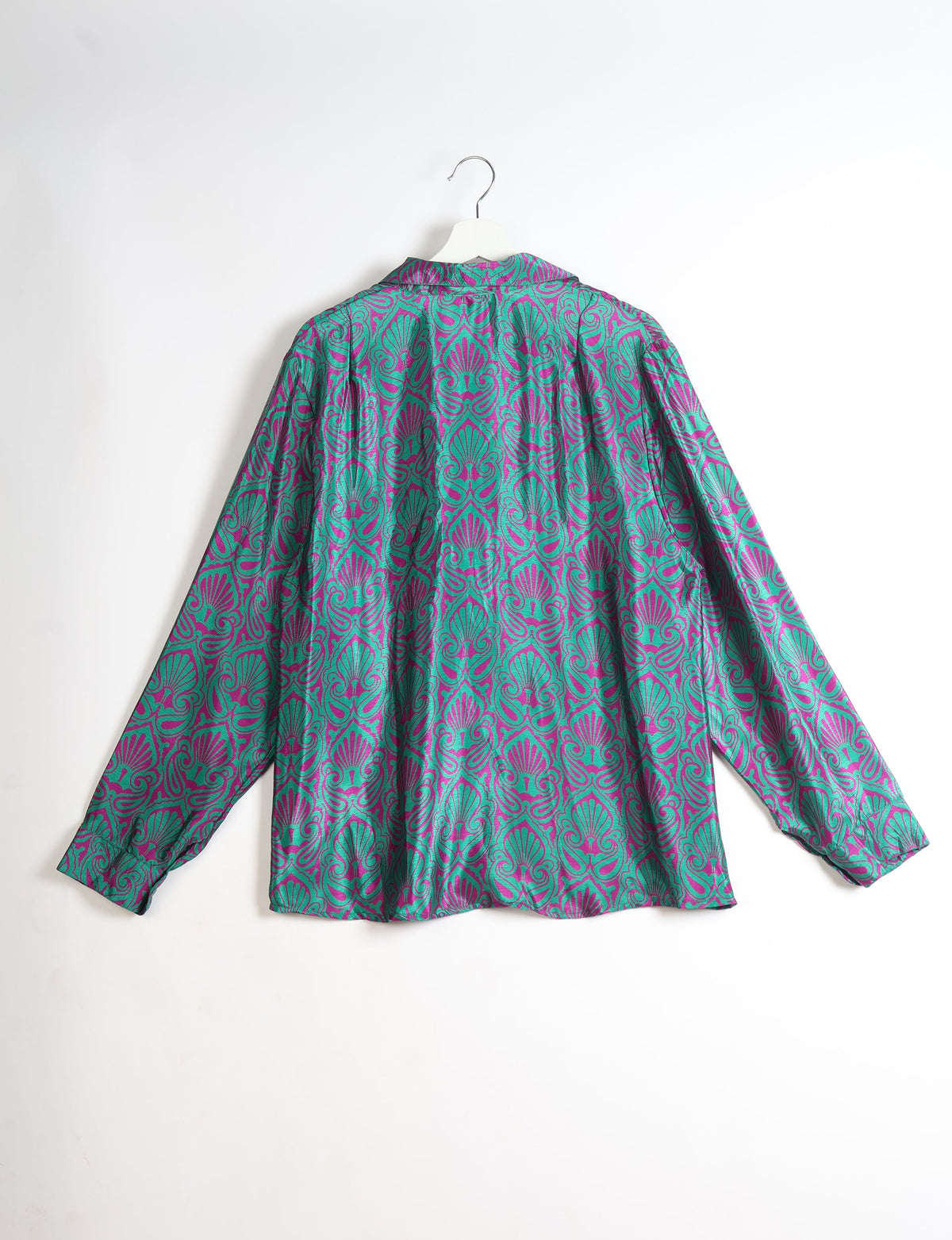 Long-sleeve shirt with green and purple ornate leaf pattern, shown from back on white hanger against white background