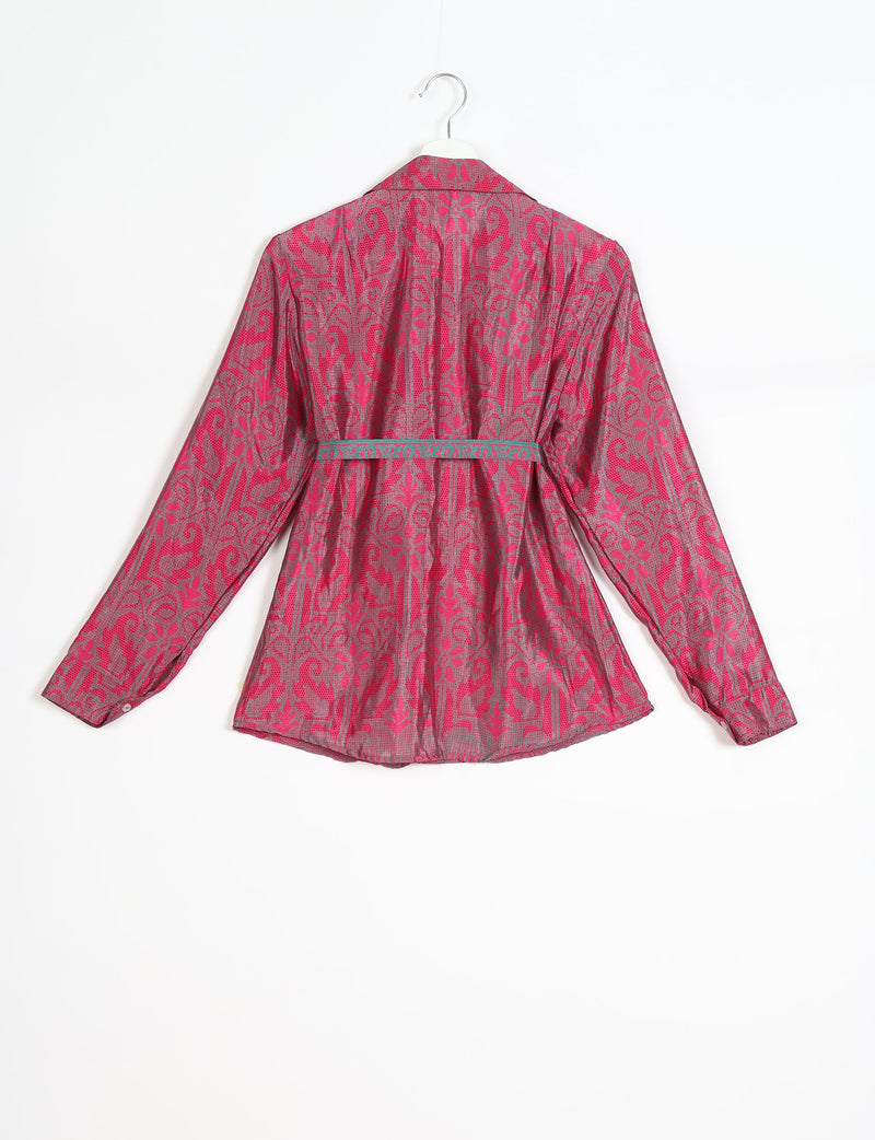 Pink and gray patterned long-sleeve shirt with a collar and a teal decorative belt, shown from the back on a hanger