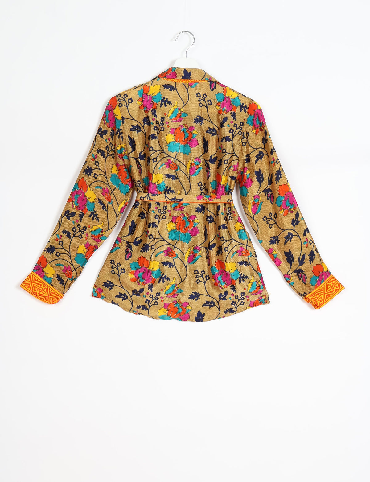 Yellow tropical floral long-sleeve shirt with orange patterned cuffs and a belt, shown from the back on a hanger