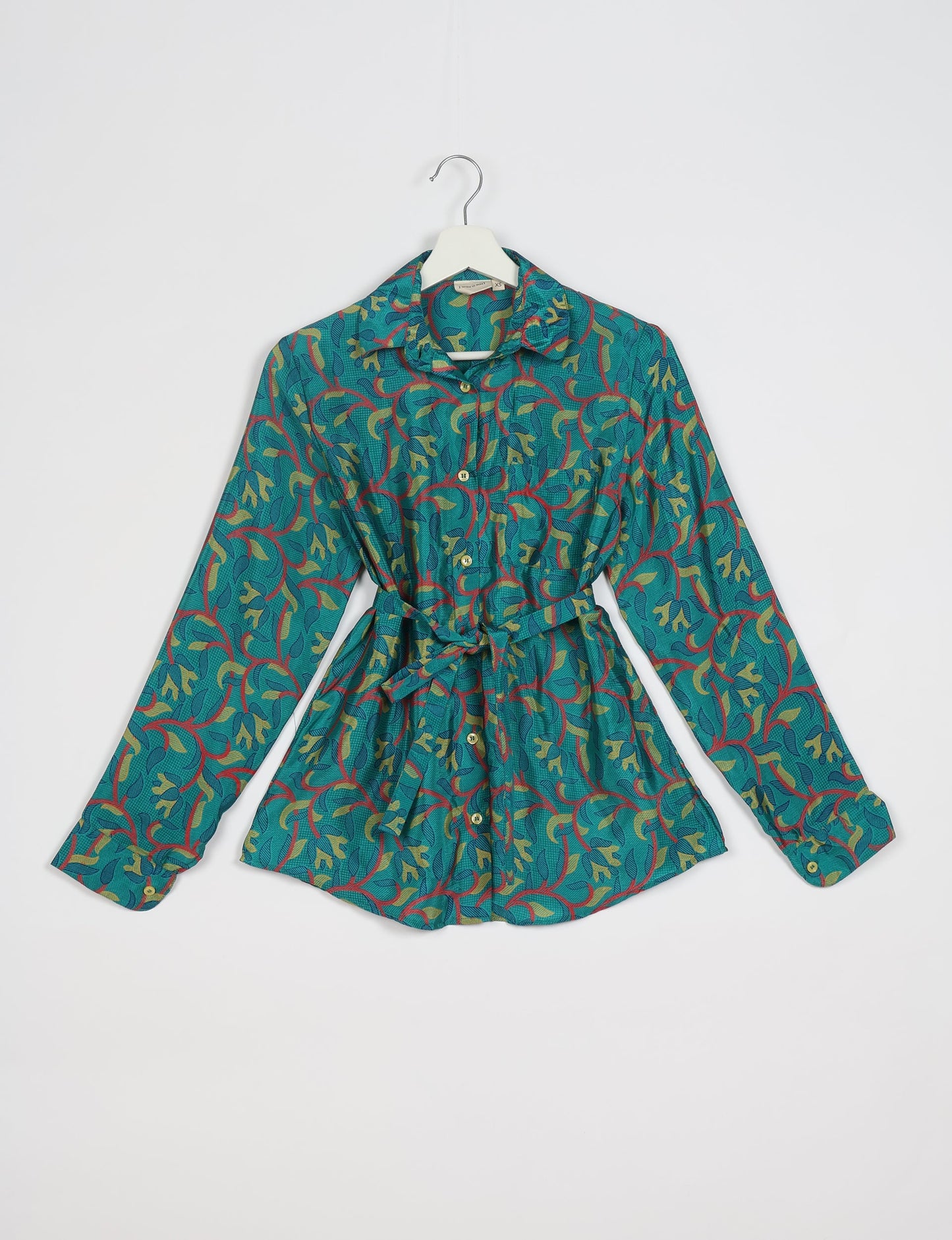 Experience sustainable fashion with our classic slim-fit shirt, crafted with ethical and green values. The shirt, designed for minimal waste, features a tie-up waist belt or neck tie, semi-spread collar, and regular shirt cuffs. Versatile and eco-friendly, wear it tucked in, unbuttoned over a tank top, or knotted at the waist for a unique style.