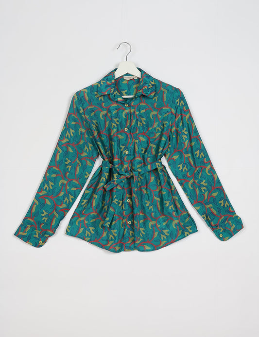 Experience sustainable fashion with our classic slim-fit shirt, crafted with ethical and green values. The shirt, designed for minimal waste, features a tie-up waist belt or neck tie, semi-spread collar, and regular shirt cuffs. Versatile and eco-friendly, wear it tucked in, unbuttoned over a tank top, or knotted at the waist for a unique style.