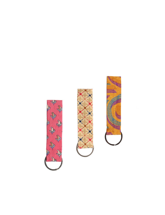 Upcycled sari fabric key ring with metal loop, made from recycled materials, promoting eco friendly fashion, sustainable apparel, zero waste clothing, climate neutral fashion, and environmentally friendly clothing.