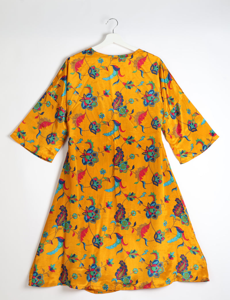 Yellow coat with multicolor tropical floral print, wide sleeves, and round neckline, shown from back on white hanger