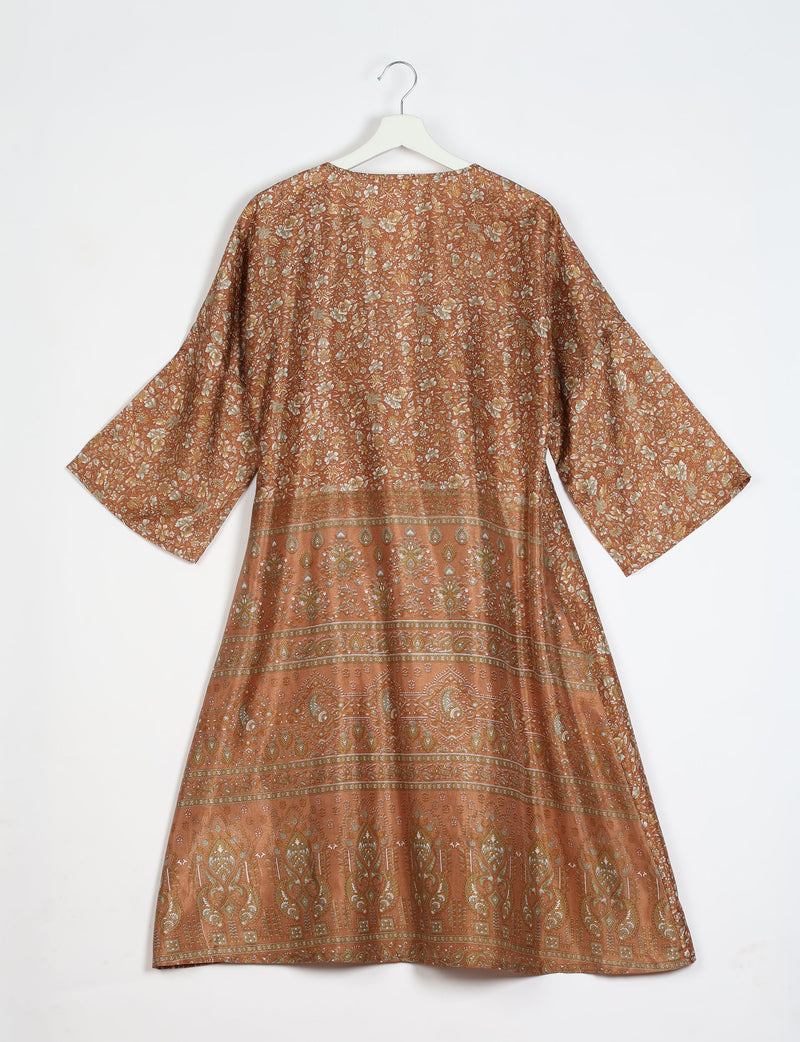 Brown tropical floral patterned coat with wide sleeves hanging on white hanger, back view