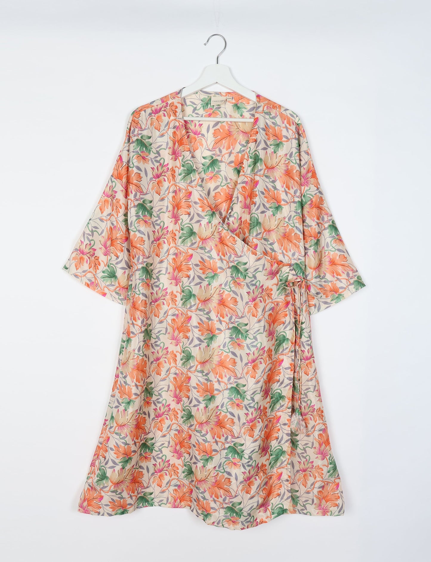 Elevate your style with our Sunset Coat, a shin-length wrap featuring a deep V-neck, wide flared 3/4 sleeves, and side tie with thread tassels. Embrace ethical and sustainable fashion with this zero waste, upcycled garment. A perfect blend of elegance and whimsy for conscious clothing enthusiasts.