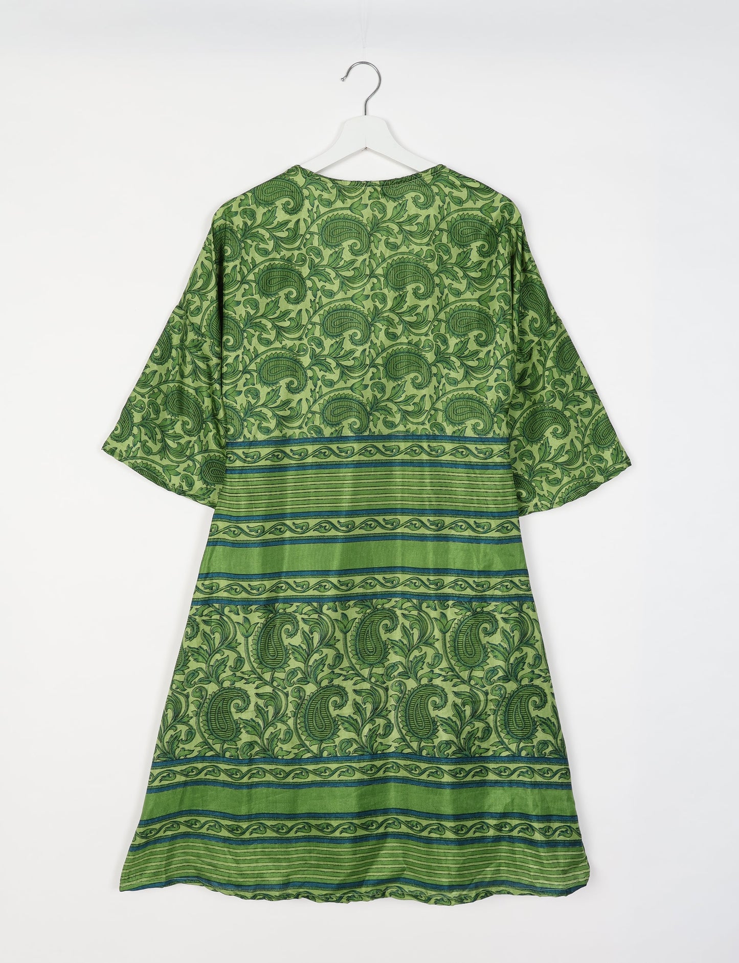 Elevate your style with our Sunset Coat, a shin-length wrap featuring a deep V-neck, wide flared 3/4 sleeves, and side tie with thread tassels. Embrace ethical and sustainable fashion with this zero waste, upcycled garment. A perfect blend of elegance and whimsy for conscious clothing enthusiasts.