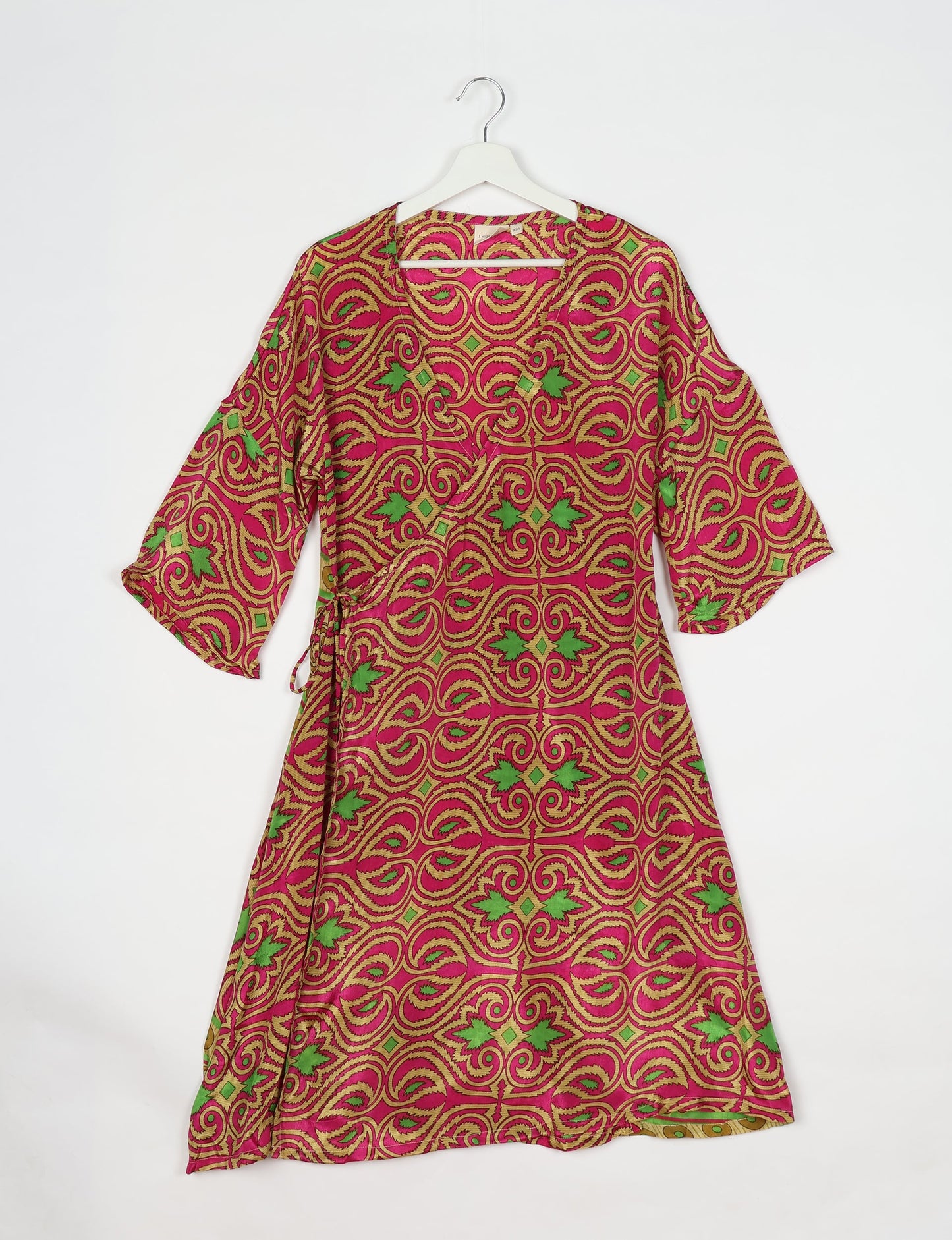 Elevate your style with our Sunset Coat, a shin-length wrap featuring a deep V-neck, wide flared 3/4 sleeves, and side tie with thread tassels. Embrace ethical and sustainable fashion with this zero waste, upcycled garment. A perfect blend of elegance and whimsy for conscious clothing enthusiasts.