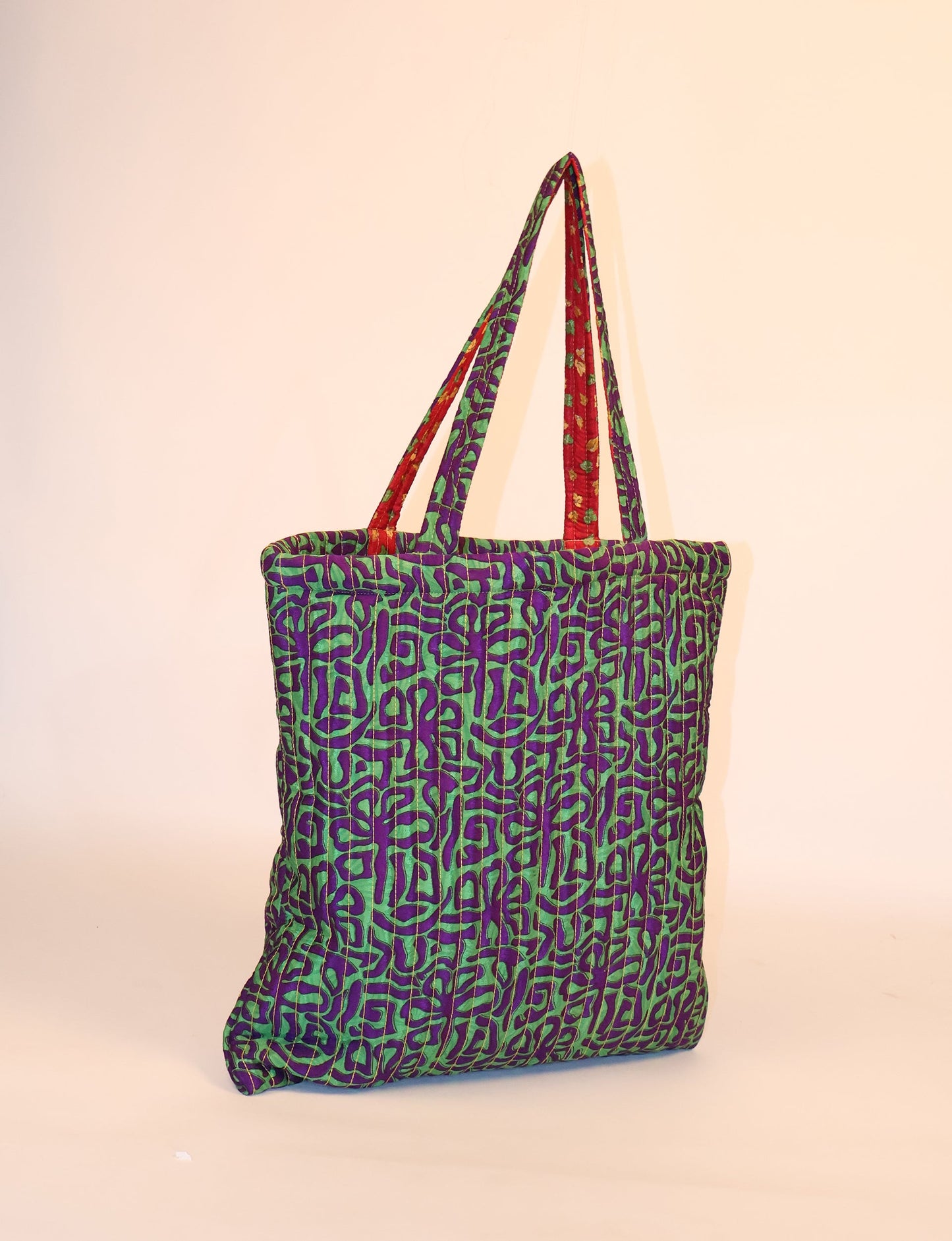 Elevate your style sustainably with our QUILTED SHOPPER BAG. Soft textures, vibrant colors, and a positive impact on people and the planet. Perfect for the office, shopping, or happy hour. Crafted from pre-loved saris for eco-conscious fashionistas!